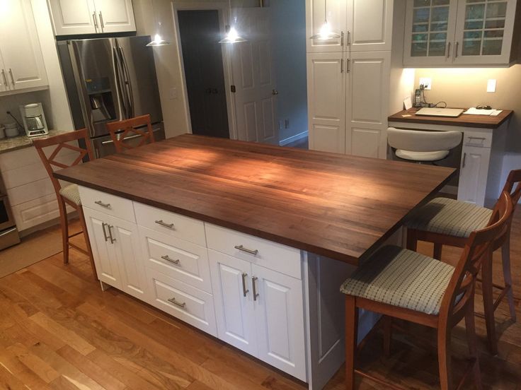 a large kitchen island with chairs around it