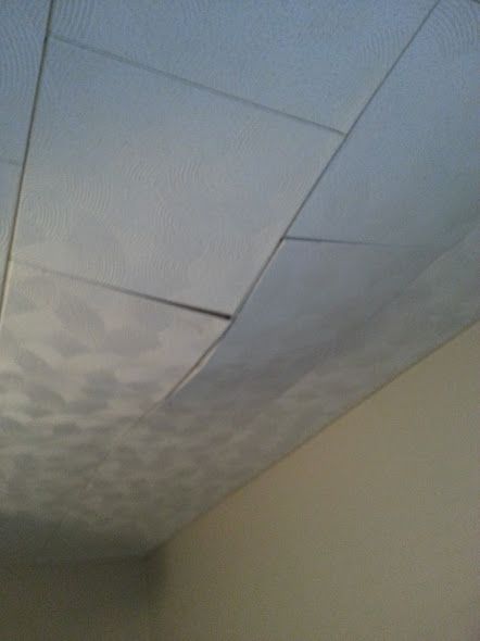 the ceiling in an office building is covered with white paint and water stains on it