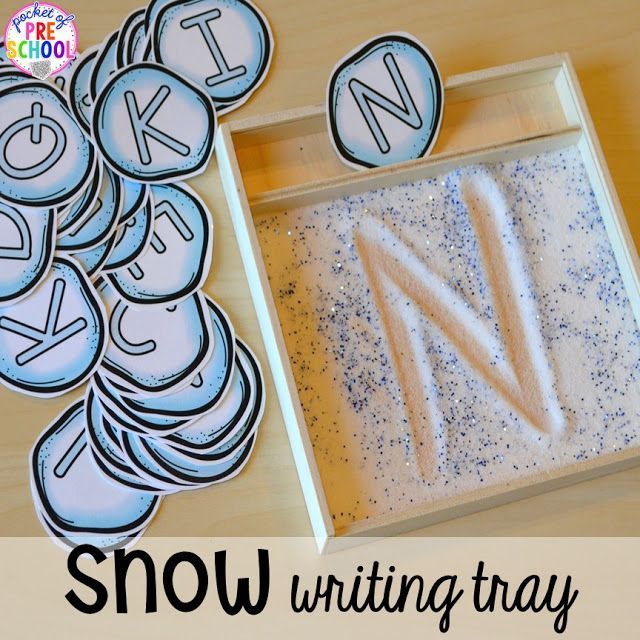 snow writing tray with letters and numbers on it