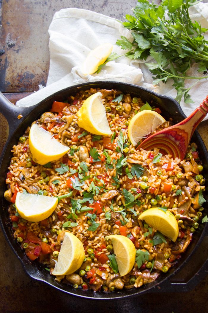 a skillet filled with rice and lemon slices