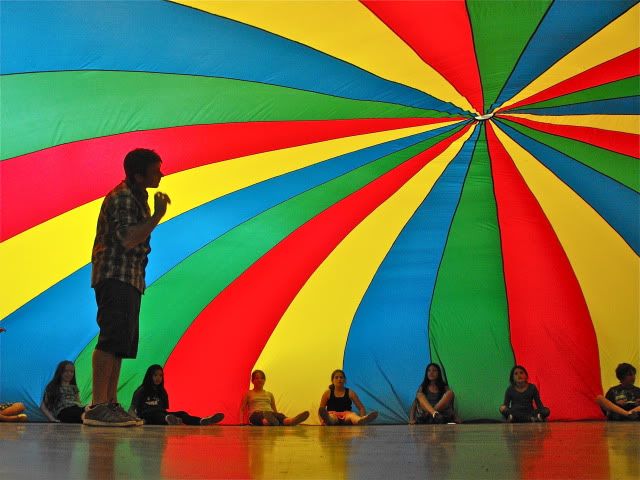 a man standing in front of a colorful umbrella