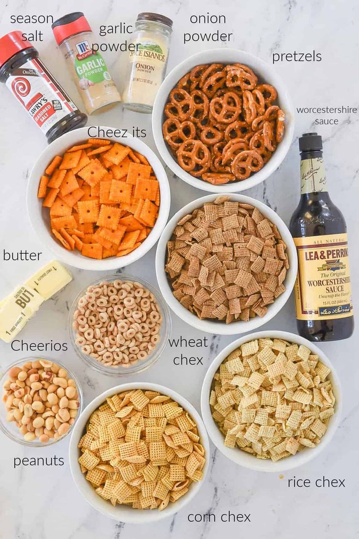 the ingredients to make cheesy crackers in bowls on a marble counter top