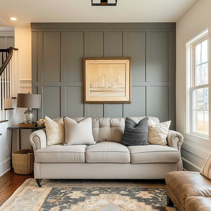 a living room filled with furniture next to a stair case