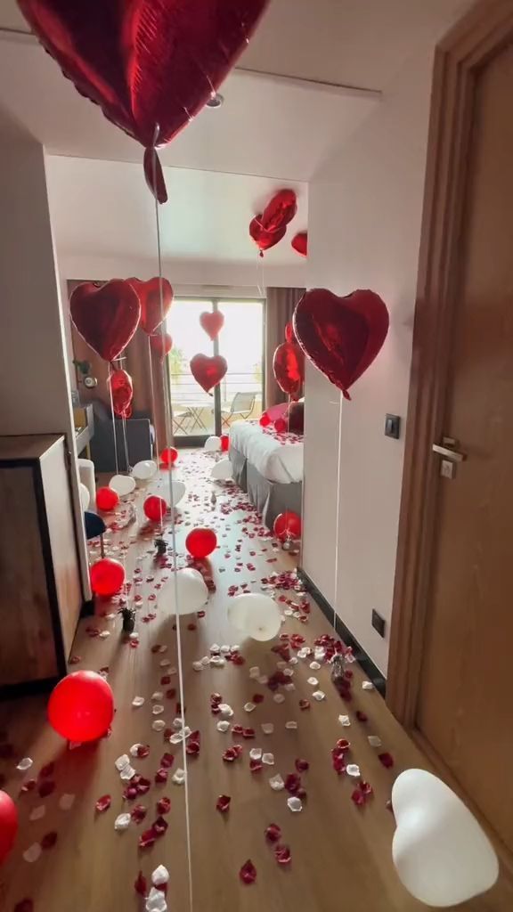 the hallway is decorated with red balloons and streamers in the shape of heart shapes