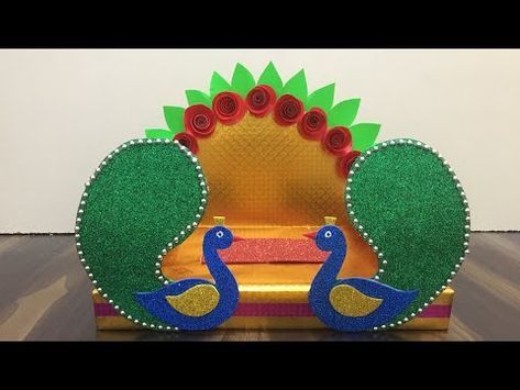 an elaborately decorated chair with two peacocks on it