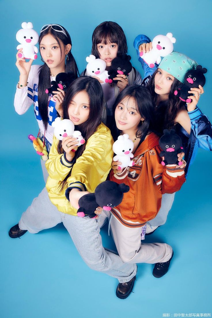 the girls are posing with stuffed animals in front of their faces and holding teddy bears