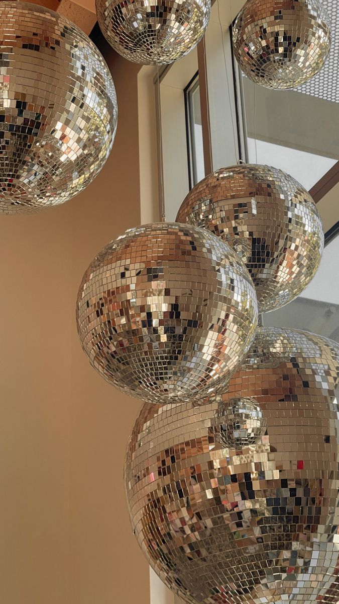 several shiny disco balls hanging from the ceiling