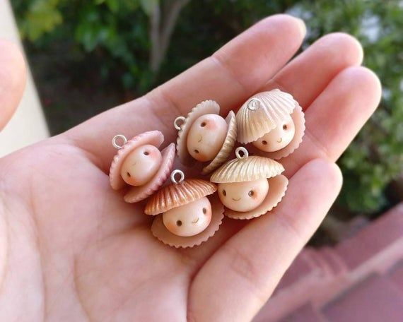 small seashells are sitting in the palm of someone's hand, which is holding them