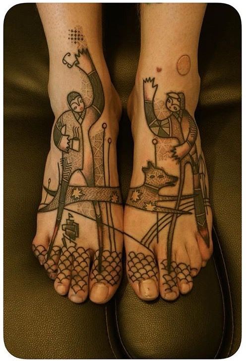 two people with tattoos on their feet