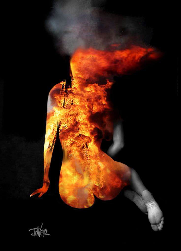 a woman is sitting in the dark with fire coming out of her back and arms