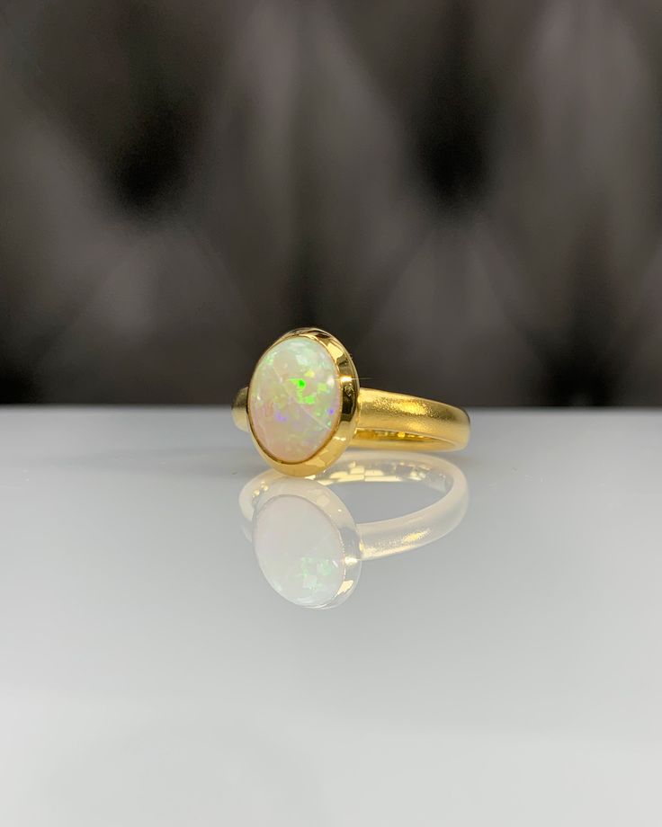 Certificated Natural Opal Dainty Cabachon Ring * 14K Solid Gold & Genuine Opal Stone * Best Gift for her * Handmade Ring ◎ Details ◎ ○ Gemstone Details .Natural OPAL Oval Cut 10.16X8.09 mm approx. 1.53 ct ○ Gold Details 14K Solid Gold Width of Band : 3.00 mm Weight of Ring : approx 4.60 gr Made to Order HANDMADE ITEM ○ Upgrade to Solid 18K Gold, please click the link below: https://www.etsy.com/listing/962826004 ◎ For more CABACHON BEZEL rings : http://etsy.me/37fvI60 All of our jewelleries Classic Cabochon Opal Ring, Gold 14k Opal Ring As Gift, 14k Gold Opal Ring For Gift, Oval Gold Opal Ring In 14k Gold, Heirloom Gold Opal Ring With Polished Finish, Elegant Gold Opal Cabochon Ring, Heirloom Gold Opal Ring With Cabochon, Heirloom Gold Opal Cabochon Ring, Luxury Gold Opal Ring Hallmarked