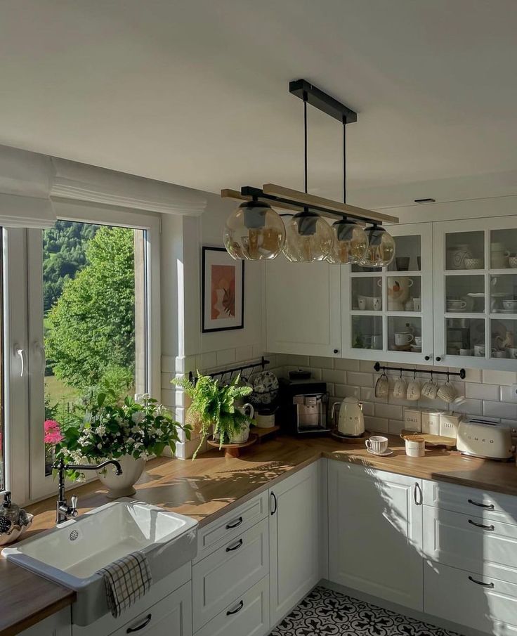 a kitchen filled with lots of counter top space next to a large open door window