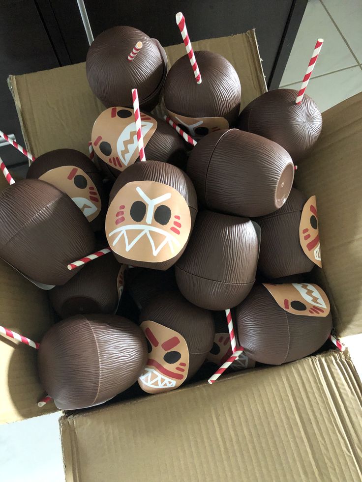 a box filled with chocolate covered donuts and candy sticks sticking out of the top