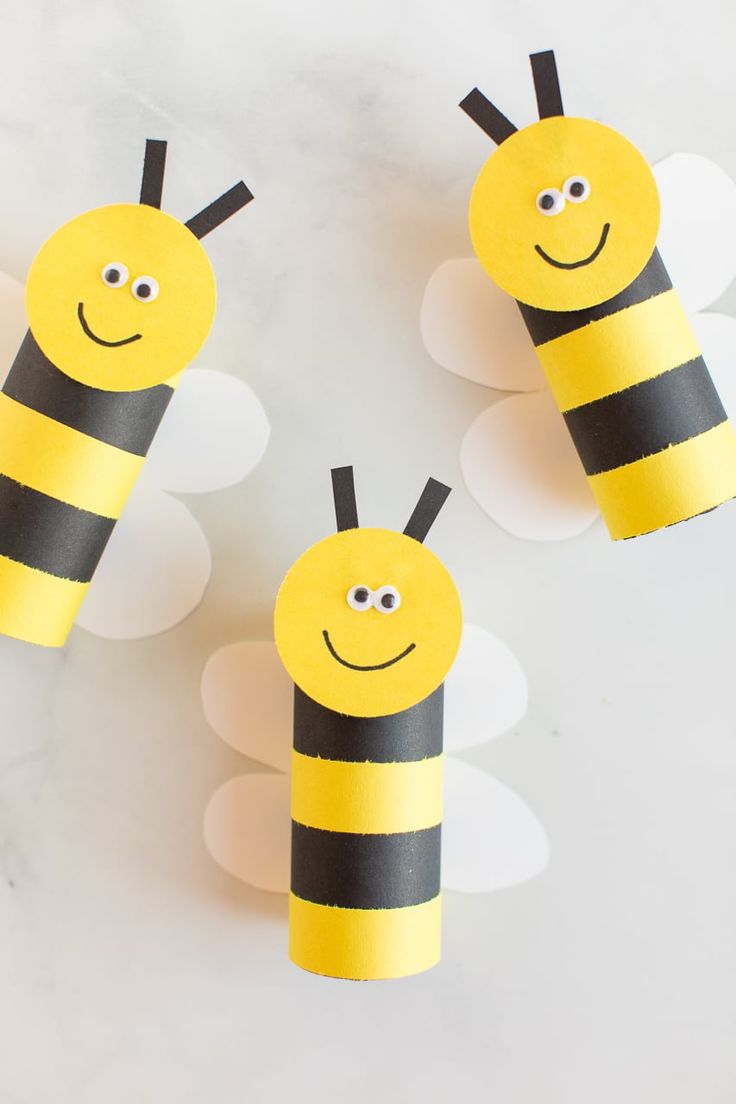 three bees made out of toilet paper sitting on top of a table