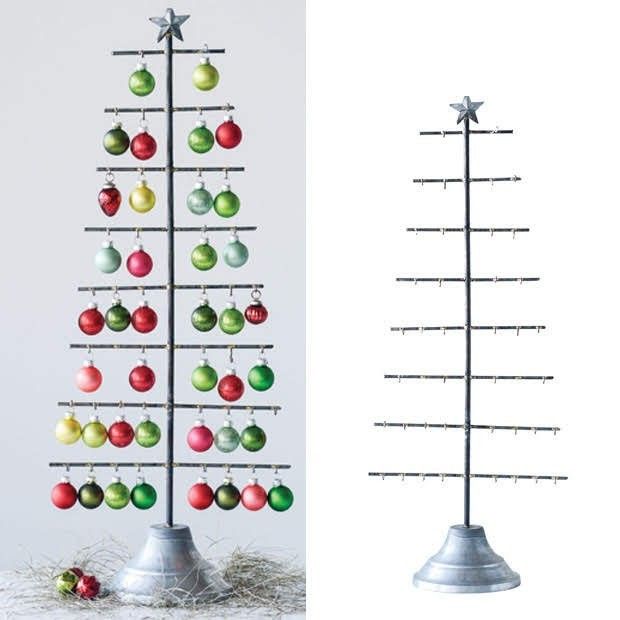 a christmas tree with ornaments hanging from it's sides and an upside down stand