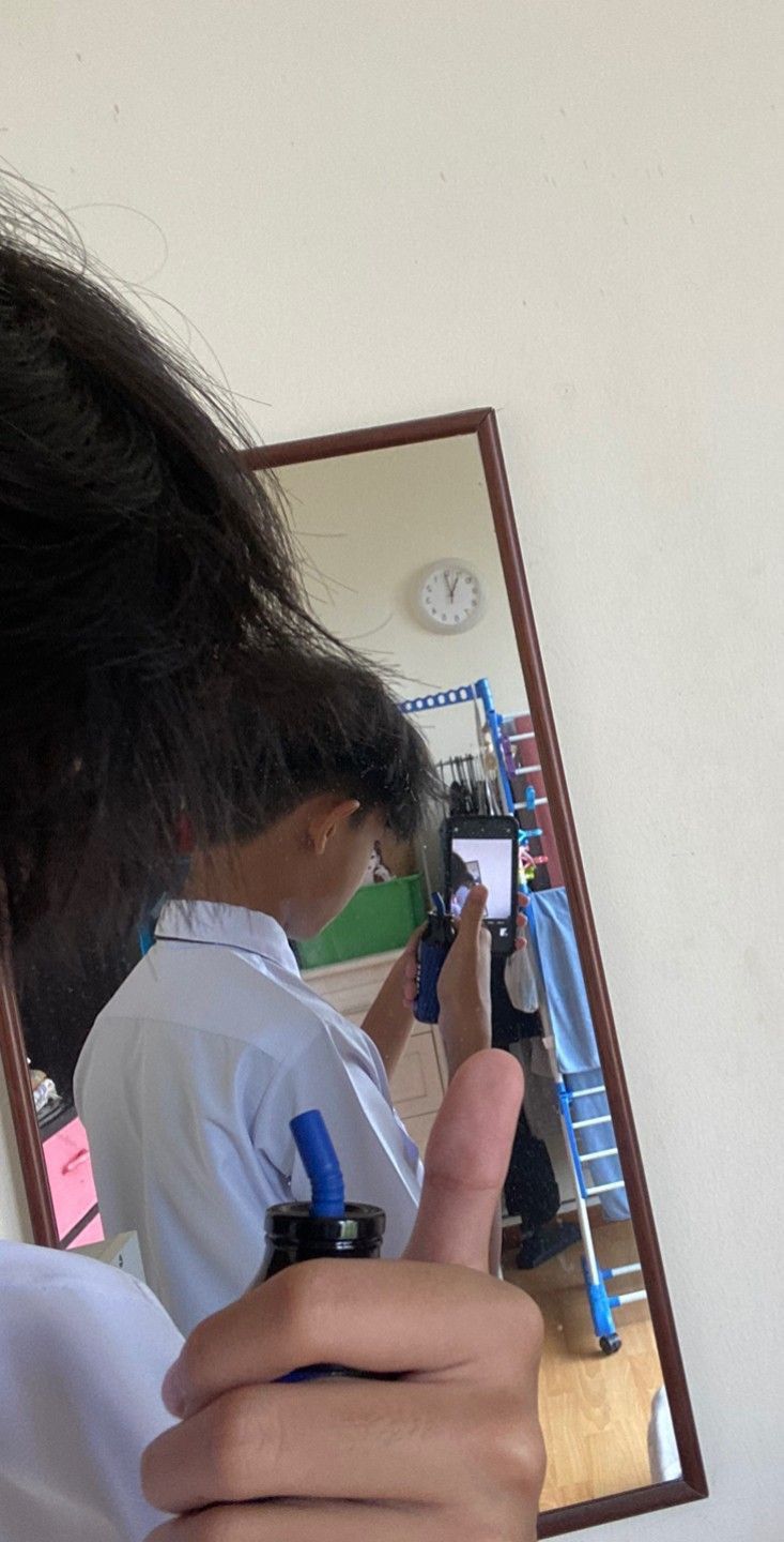 a person taking a selfie in front of a mirror