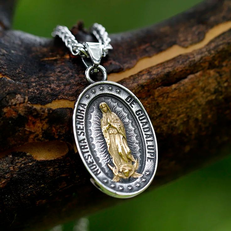 Embrace divine protection with our Guadalupe Medallion. This exquisite pendant features a detailed depiction of Virgin Mary, rendered in a stunning two-tone finish. The central golden figure radiates against an antique silver background, encircled by stars and a meaningful inscription. Crafted with meticulous attention to detail, this piece serves as both a spiritual talisman and a work of art. Whether worn as a personal devotional or gifted to a loved one, this medallion offers a daily connection to faith, hope, and celestial guidance. Vintage-inspired design with strong religious symbolism Premium 316L stainless steel - Lightweight, hypoallergenic and tarnish-resistant Retro chain included (24 inches length) With bail 45mm x 28. Without bail 35mm x 28mm Virgin Mary Pendant - Symbol of Pu Silver Virgin Mary Pendant Jewelry, Silver Our Lady Of Guadalupe Pendant Jewelry, Silver Spiritual Virgin Mary Jewelry, Spiritual Silver Jewelry With Virgin Mary, Spiritual Silver Necklace With Our Lady Of Guadalupe, Lady Of Guadalupe Necklace, Guadalupe Necklace, Virgin Mary Pendant, Divine Protection