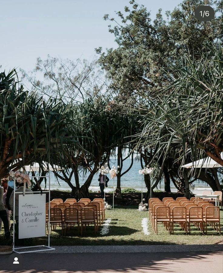 an outdoor ceremony set up with chairs and trees