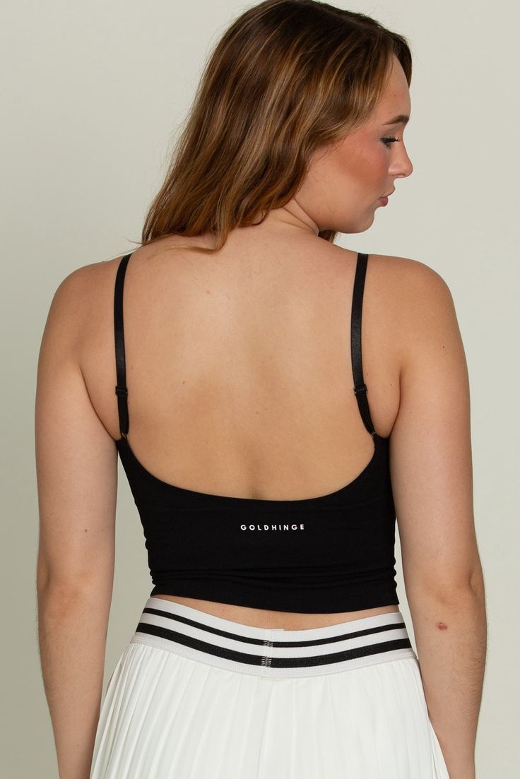 Our famously Best Selling Black Original Ribbed Yoga Tank is the same loved style style as our other Original Ribbed Yoga Tanks, now in a staple black. It's one size fit stretches and confirms to any size so easily, so no worries there. It features adjustable straps for any shoulder shape and has supported removal padding for your preference. This tank features a modest cut front, cropped fit and a flattering low cut back. Black Stretch Crop Top With Built-in Bra, Black Ribbed Stretch Activewear, Black Stretch Ribbed Activewear, Trendy Black Yoga Sports Bra, Trendy Black Sports Bra For Yoga, High Stretch Black Bra-friendly Tops, High Stretch Black Bra Friendly Tops, Black High Stretch Bra Friendly Tops, Black High Stretch Bra-friendly Tops