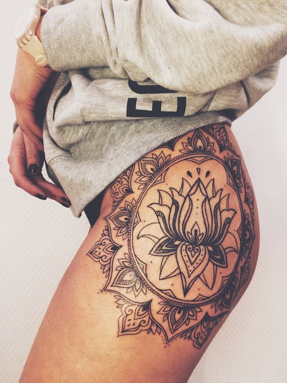 a woman's thigh with a tattoo on it