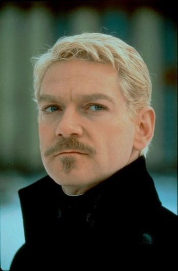 a man with blonde hair and a moustache on his face