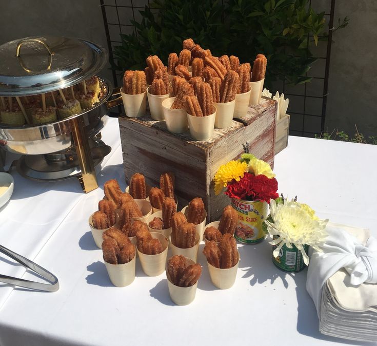 a table topped with lots of food next to a wooden box filled with fried chicken nuggies