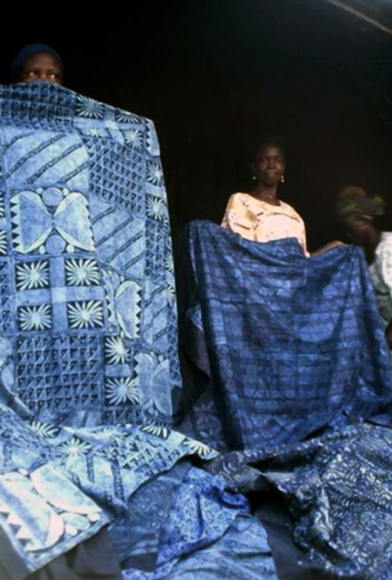 two women are holding blue cloths in their hands