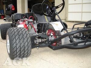 an off - road vehicle parked in front of a garage with two tires on it