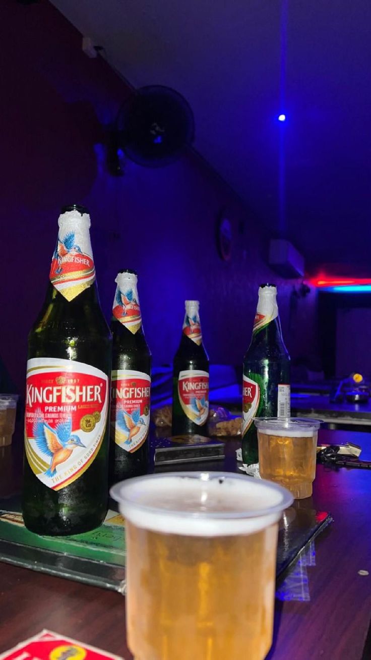 several bottles of beer sitting on top of a wooden table