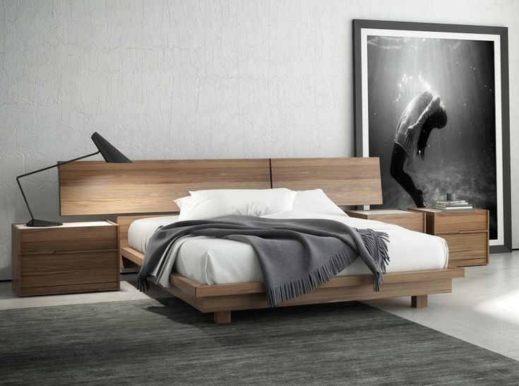 a modern bedroom with white walls and wood furniture