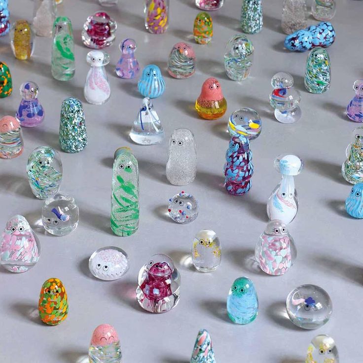 many different colored glass bottles on a table