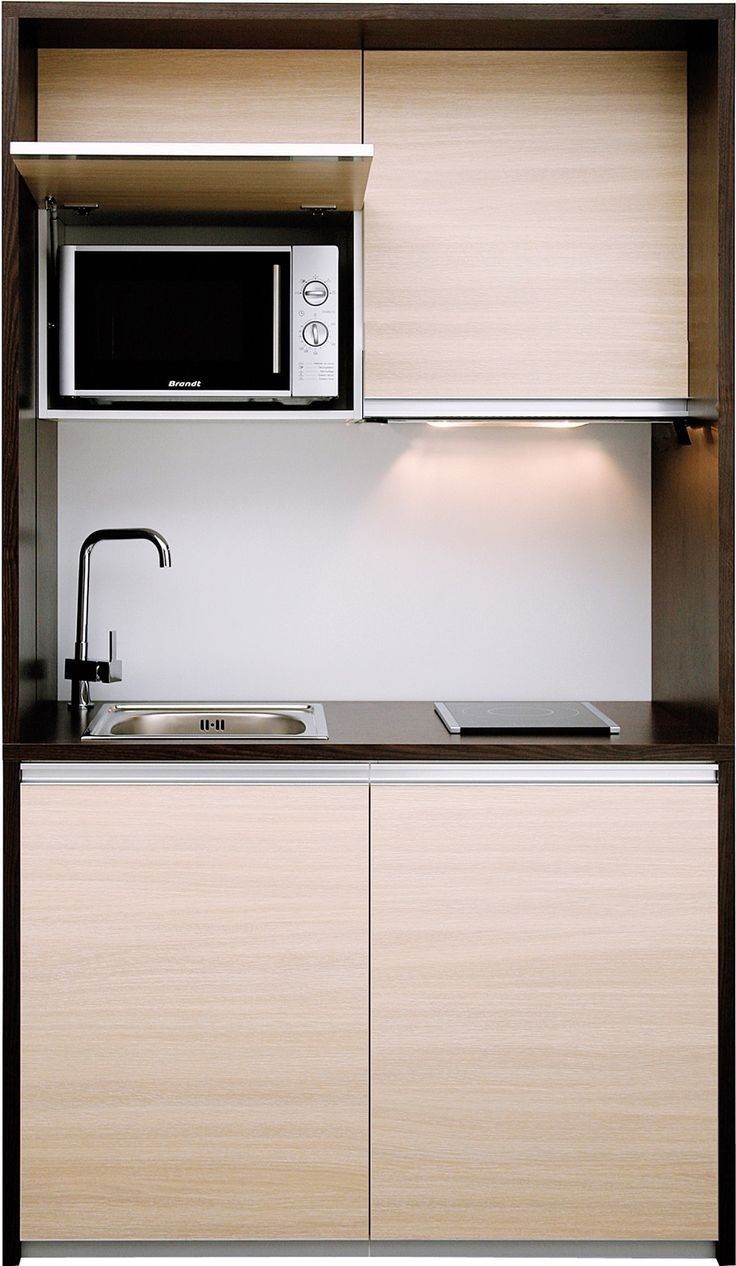 a microwave oven sitting above a sink in a kitchen