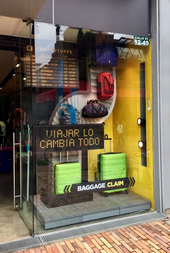 the front window of a luggage claim store