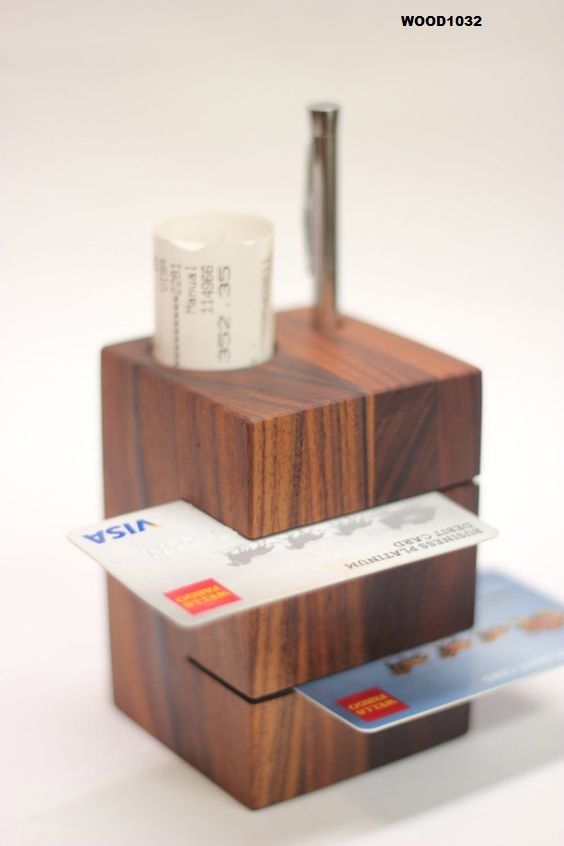 a wooden holder with two credit cards and a coffee cup on top, sitting next to each other