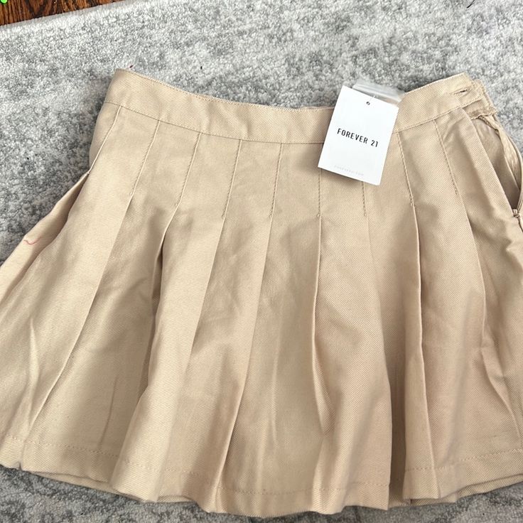 Brand New, Khaki Pleated Skirt. Size Is 9/10 But It Runs Small, I’d Say Fits Like A Size 8 High-waisted Pleated Skirt For School In Spring, Trendy Flared Mini Skirt For School, Trendy Summer Skirt For School, School Uniform Mini Skirt With Lining, Summer School Flared Skirt, School Uniform Style Mini Pleated Skirt, Summer School Pleated Lined Skirt, High-waist Tennis Skirt For School In Spring, High Waist Tennis Skirt For School In Spring