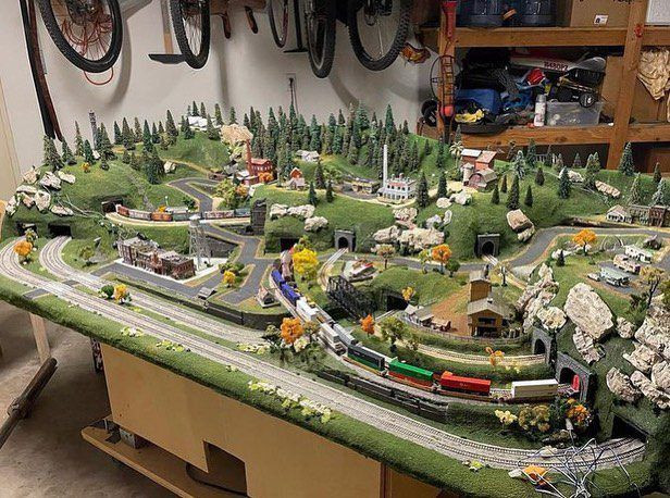 a model train set is displayed on a table