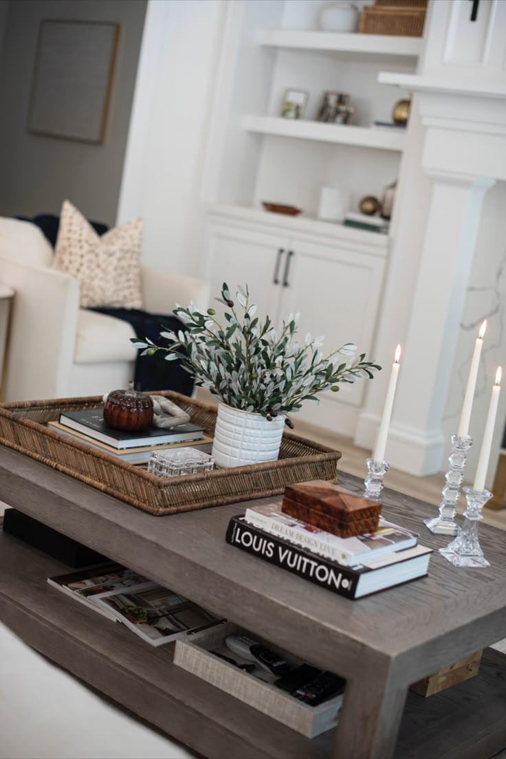 a coffee table with books and candles on it