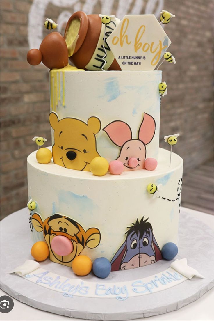 a winnie the pooh birthday cake is on display