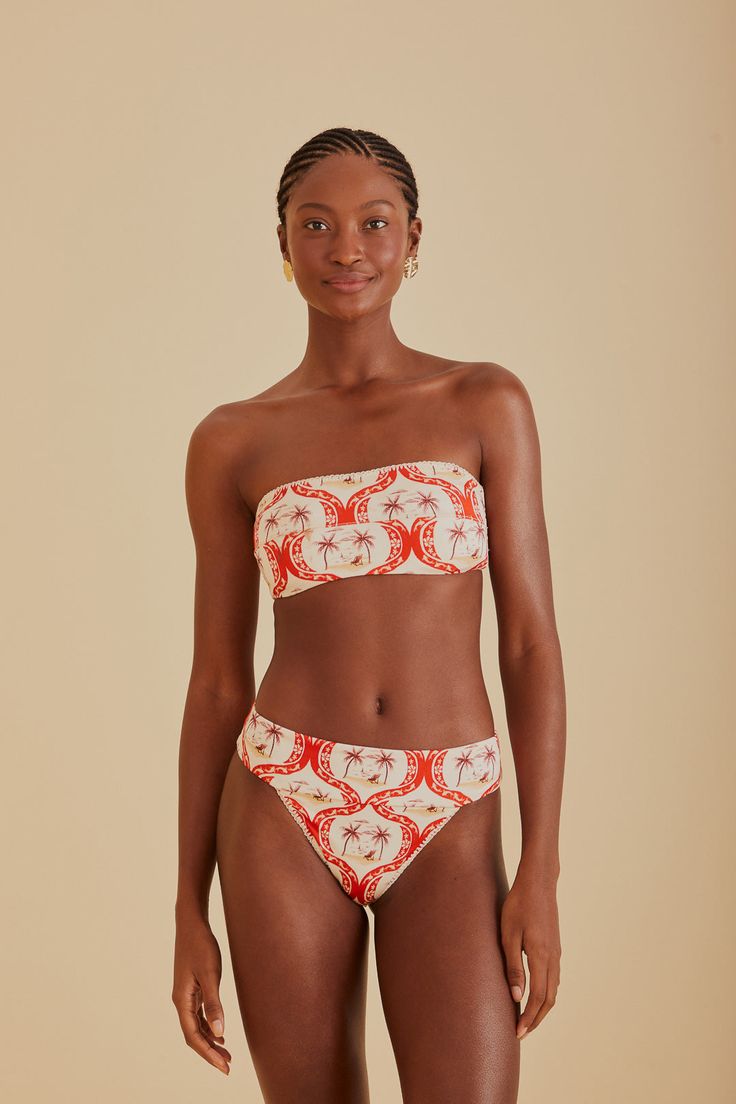 Embrace the vibrancy of summer with the FARM Rio Summer Beach Bikini Bottom. Its vivacious red and white pattern draws inspiration from tropical havens, making every moment feel like a sunny escape. The flattering high-leg cut and comfortable mid-rise waist complement your natural silhouette, while the playful tie-back detail on the coordinating top adds a touch of whimsy to your beach ensemble. Ideal for those who love to stand out with a touch of Brazilian flair. Composition 85% POLYAMIDE 15% ELASTANECare Instructions MAXIMUM WASHING TEMPERATURE 30°C, MILD PROCESS, DO NOT BLEACH, TUMBLE DRYING POSSIBLE, DO NOT IRON, DO NOT DRY CLEANSize and Fit Inches XXS XS S M L XL Bust N/A N/A N/A N/A N/A N/A Waist 22 25 27 28 30 31 Length N/A N/A N/A N/A N/A N/A Hip 34 37 39 40 43 43 Tropical Swimwear For Beach Party During Resort Season, Summer Bandeau Swimwear With Floral Print, Beachy Bandeau Swimwear With Floral Print, Tropical Bandeau Swimwear For Vacation, Tropical Print Bandeau Swimwear For Beach Season, Bandeau Swimwear With Tropical Print For Beach Season, Vacation Bandeau Swimwear With Floral Print, Bandeau Swimwear With Floral Print For Vacation, Bandeau Swimwear For Vacation Beach Season