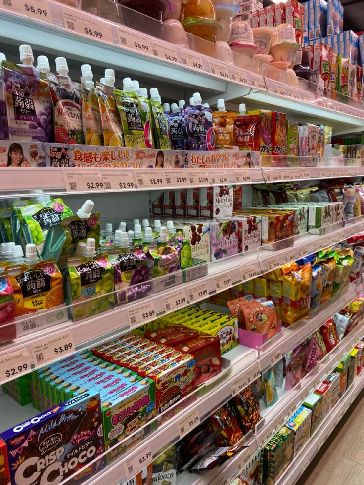 shelves in a grocery store filled with lots of different types of drinks and snacks on display