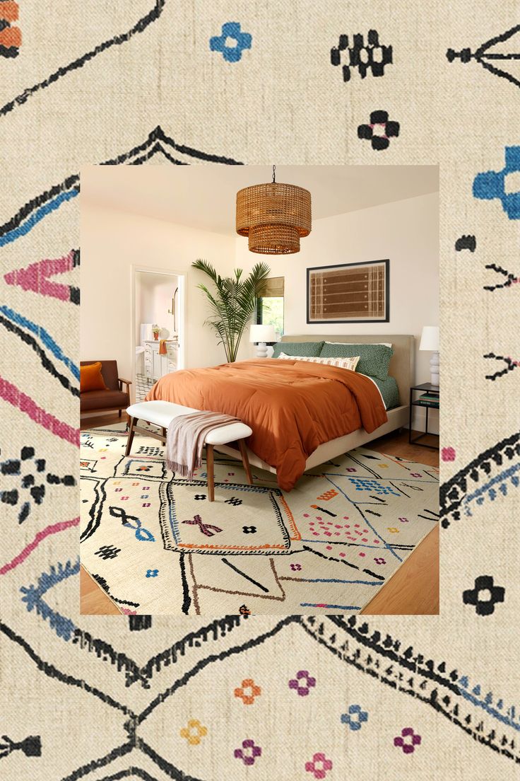 a bedroom with an orange bed and colorful rugs on the floor in front of it