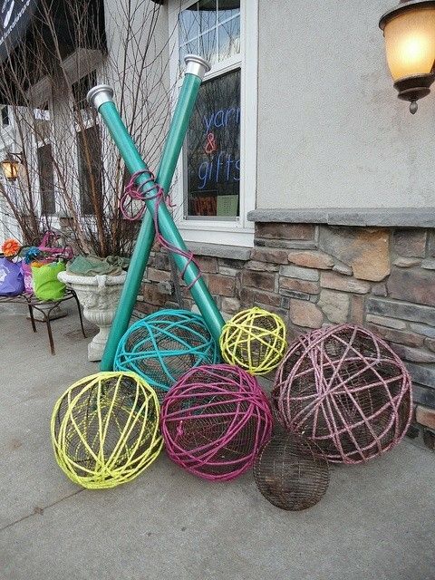 several different colored wire balls on the ground