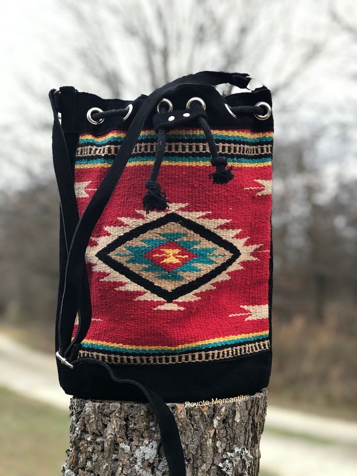 Red and Black woven southwestern bucket bag Southwestern Multicolor Bags For Everyday Use, Multicolor Southwestern Bags For Everyday Use, Southwestern Multicolor Everyday Bags, Red Bohemian Bucket Bag For Daily Use, Red Bohemian Bucket Bag For Travel, Bohemian Red Bucket Bag For Daily Use, Multicolor Southwestern Style Everyday Bags, Artisan Bucket Bag With Adjustable Strap For Travel, Multicolor Southwestern Everyday Bags