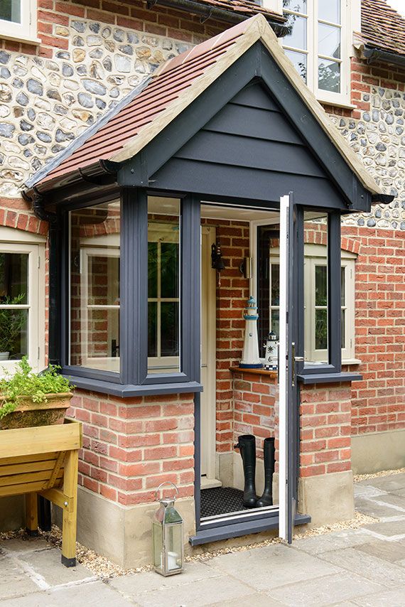 a small brick house with an enclosed patio