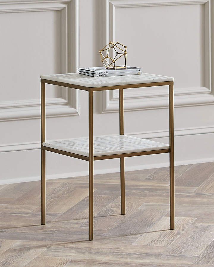 a white marble top end table with gold legs