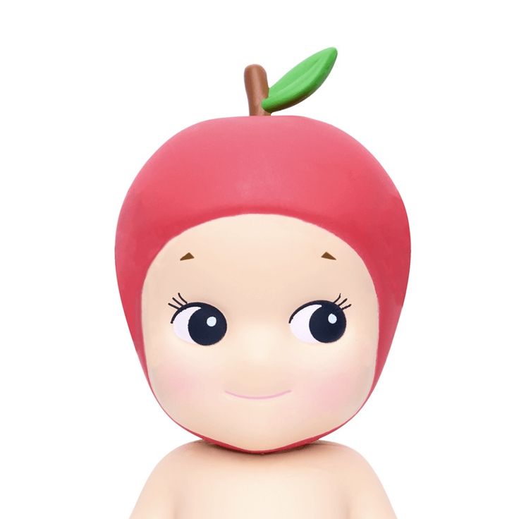 an apple toy with eyes and a green leaf on it's head, sitting in front of a white background