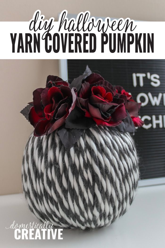 yarn covered pumpkin with flowers in it and text overlay that reads diy halloween yarn covered pumpkin