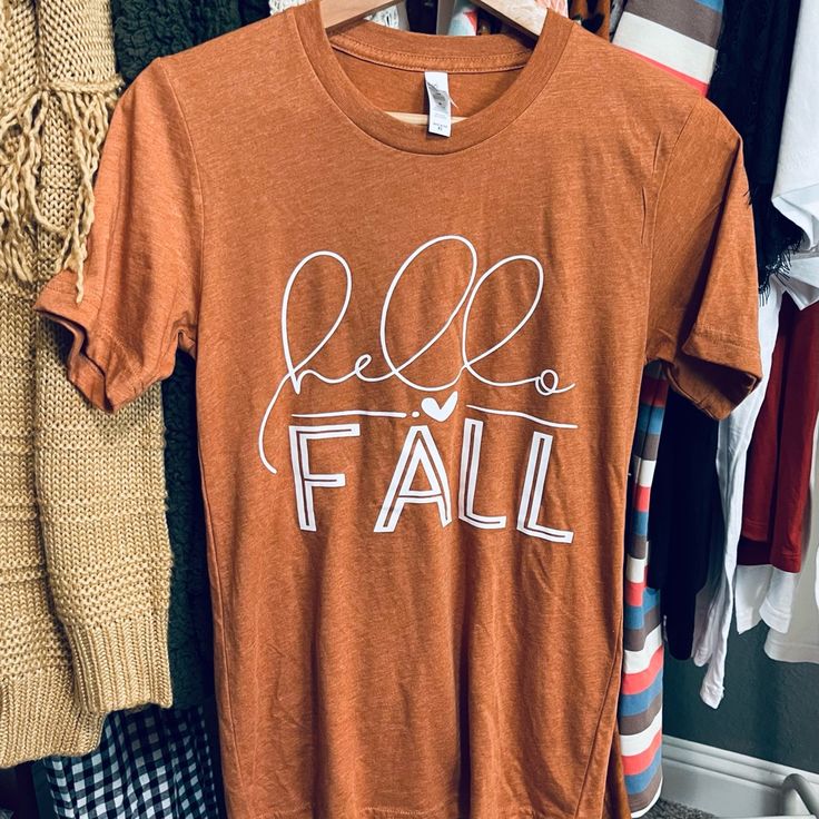 Never Worn T-Shirt Casual Brown T-shirt For Fall, Casual Graphic Print T-shirt For Fall, Casual Fall T-shirt With Graphic Print, Fall Crew Neck T-shirt With Graphic Print, Fall Graphic Print Crew Neck T-shirt, Everyday Fall Slogan T-shirt, Fall Graphic Tee Soft-washed, Brown Screen Print Top For Fall, Casual Brown T-shirt With Text Print