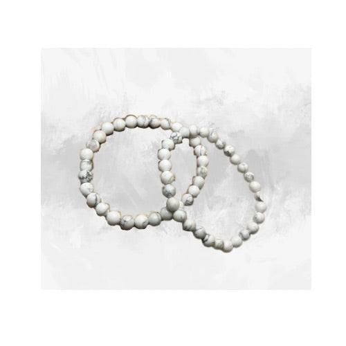 Immerse yourself in the innate calmness of our White Howlite Bracelet. Each piece is handcrafted with love, using grade AAA 8mm Howlite beads, effortlessly strung on a durable stretch cord. This unique piece not only serves as a stylish accessory but also a tranquil companion, known for its soothing energies. The bracelet's clean and polished finish ensures a comfortable fit and a timeless look that effortlessly complements any outfit. Alongside its aesthetic allure, the bracelet brings the spiritual benefits of Howlite, a gemstone believed to promote relaxation and emotional well-being. Elegant White Beaded Bracelets With 8mm Beads, Handmade White Crystal Round Bracelet, Handmade White Crystal Bracelet, Hand-strung Howlite Jewelry With Round Beads, Adjustable White Crystal Bracelet With Natural Stones, Adjustable White Crystal Bracelet With Gemstone Beads, Howlite Bracelets With Round Beads As Gift, White Beaded Bracelets With 108 Beads For Meditation, Hand-strung Round Howlite Beads Jewelry