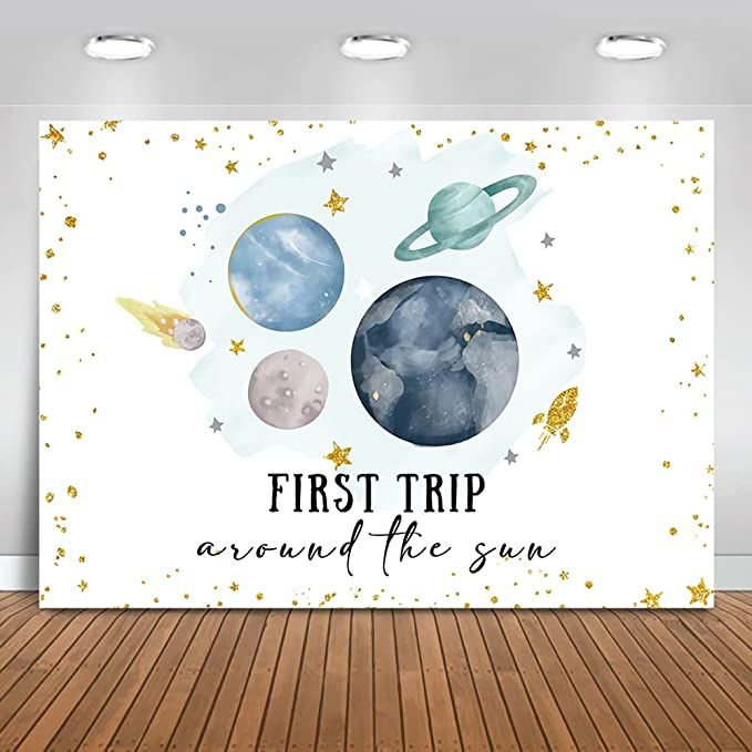 the first trip around the sun with planets and stars on it is displayed in an empty room